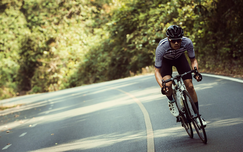 Man cycling bike or bicycle. 6 ways a chiropractor can help your bike ride